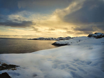 Scenic view of frozen sea against sky during winter