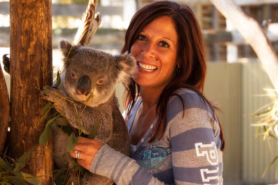 Portrait of woman with koala at zoo