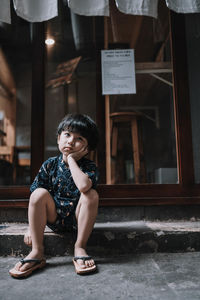 Portrait of a smiling girl sitting outdoors