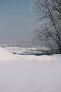 Snow covered landscape against sky