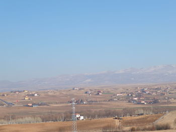 Scenic view of agricultural field against clear blue sky