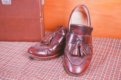 Close-up of shoes on tiled floor