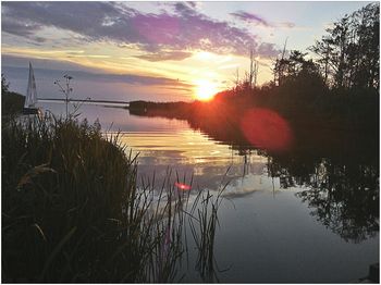 Scenic view of lake at sunset