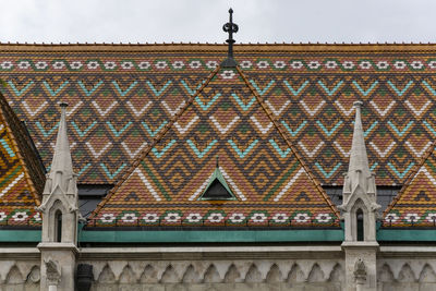 Low angle view of building roof against sky