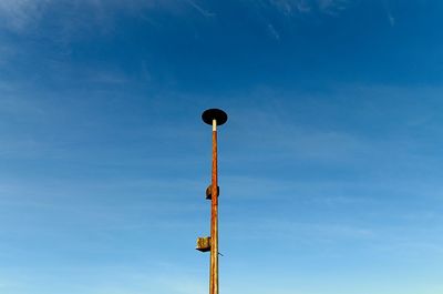 Low angle view of street light against sky