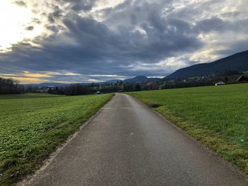 Empty road along countryside landscape