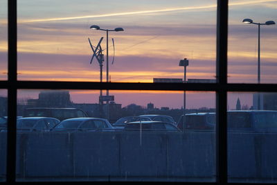 Street lights against orange sky