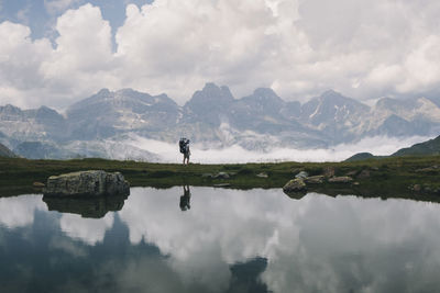 Young woman stands at the view with her son in the baby carrier, spain