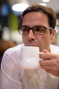 Portrait of man drinking coffee