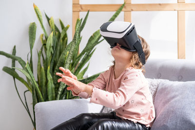 Girl using vr while sitting at home