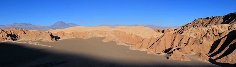 Scenic view of mountains against clear blue sky