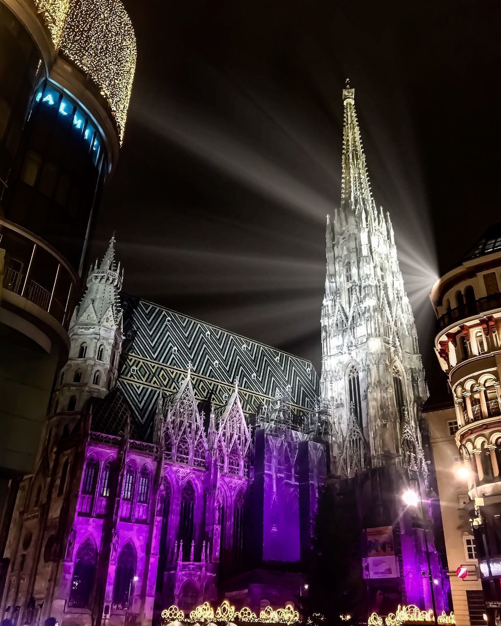 LOW ANGLE VIEW OF ILLUMINATED BUILDINGS AT TEMPLE