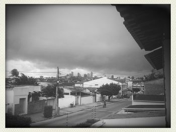 Buildings in city against cloudy sky