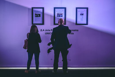 Full length of couple standing in museum