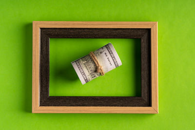 Directly above shot of old green hanging over white background