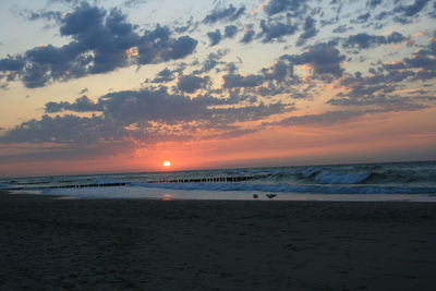 Scenic view of beach against sky during sunset