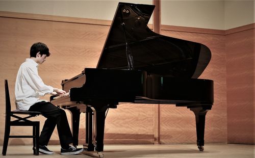 Teenage boy playing piano