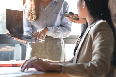 Midsection of woman working on table