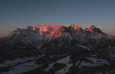 Scenic view of snowcapped mountains against sky during winter