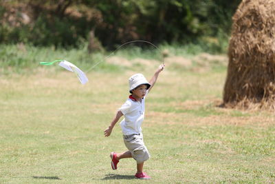 Full length of boy playing on grass