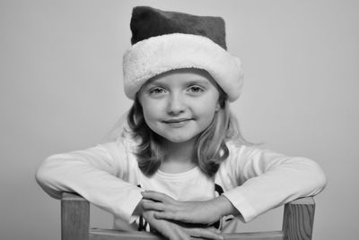 Portrait of smiling young woman against wall