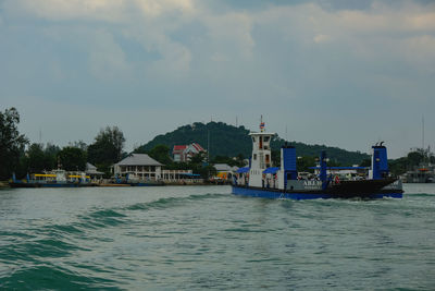 Scenic view of sea by buildings against sky