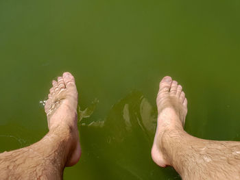 Low section of men by lake