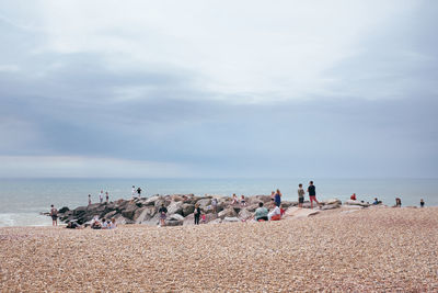 People on beach against sky