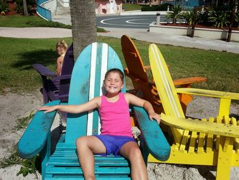 Portrait of smiling girl sitting in park