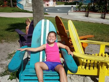 Portrait of smiling girl sitting in park