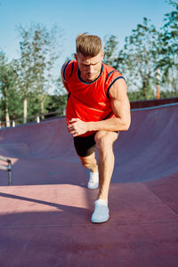 Full length of man exercising on road