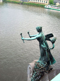 Statue against water