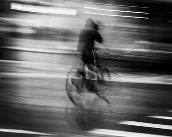 Blurred motion of man riding bicycle