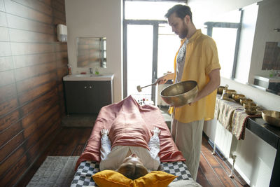 Midsection of man holding food at home