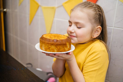 Girl with a fragrant homemade cupcake, home cooking, easter holiday