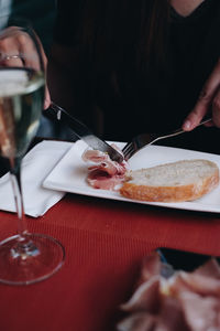 Midsection of woman having food in restaurant