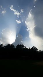 Scenic view of field against cloudy sky