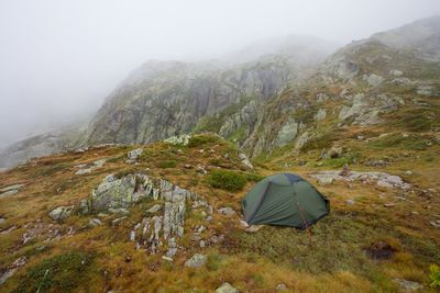 Scenic view of tent on mountain against clear sky