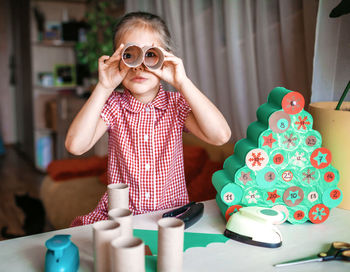 Portrait of girl preparing christmas decoration at home