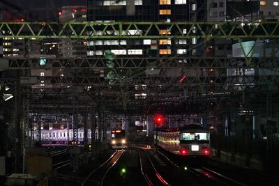 Railroad tracks in city at night