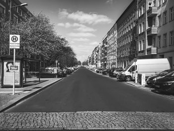 Road amidst city against sky