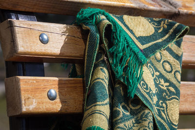 Close-up of rug on wooden bench