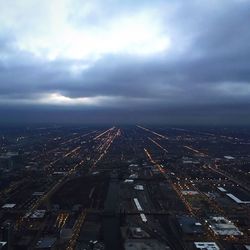 Aerial view of city against cloudy sky