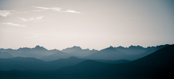 Scenic view of silhouette mountains against sky