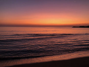 Scenic view of sea against romantic sky at sunrise