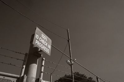 Low angle view of information sign against clear sky