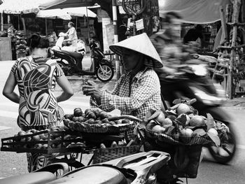 People at market stall in city