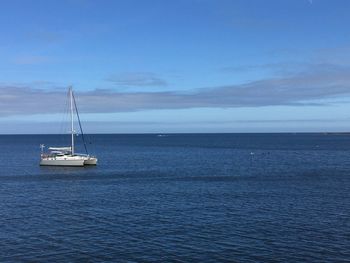 Boat out at sea, outside mevagissey harbour, cornwall, beautiful blue sky and tranquil water