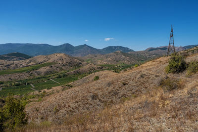 Scenic view of mountains against clear blue sky