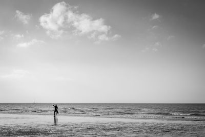 Man standing on beach against sky